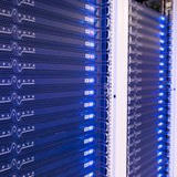Rows of blue-lit Amplidata storage server racks with labeled front panels stand in a data center aisle.